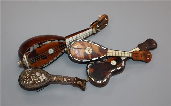 Four Italian tortoiseshell and mother of pearl models of mandolins and guitars